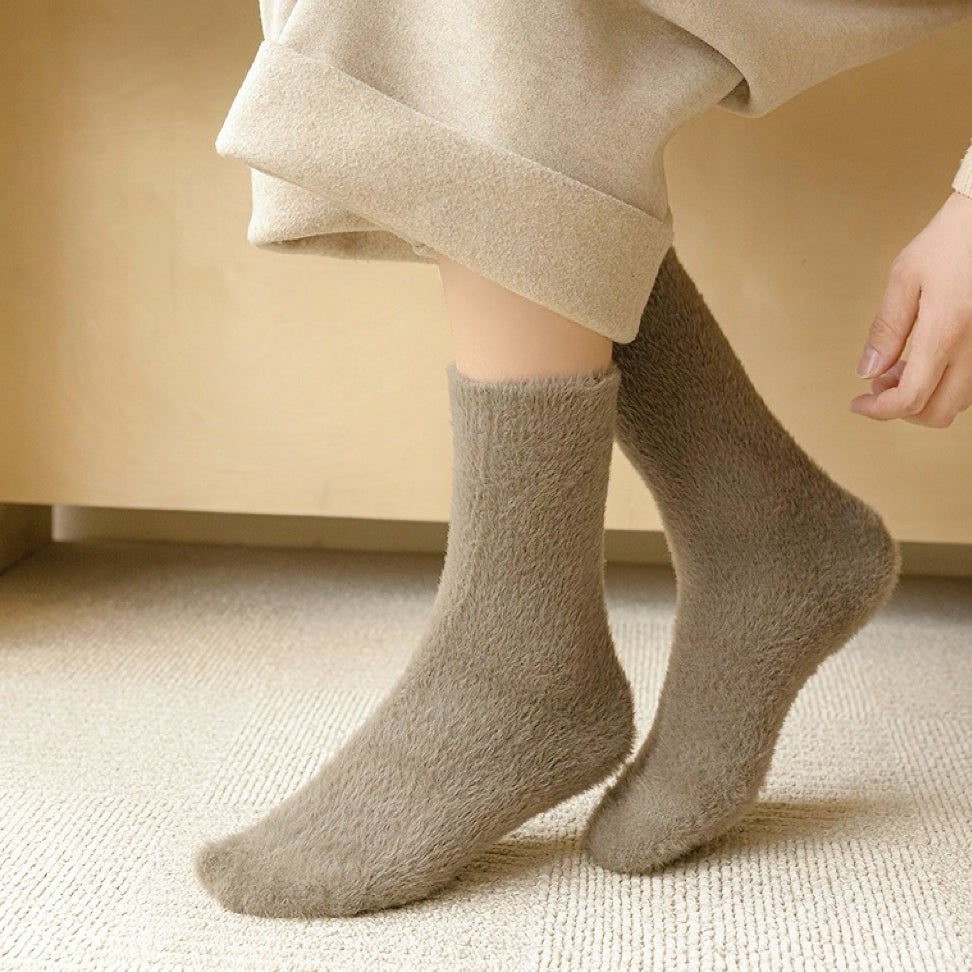 Model wearing a pair of dark khaki Plush Cozy Socks, great for casual wear and light workouts.