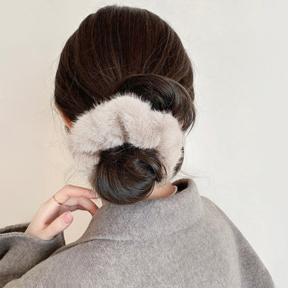 Model wearing Plush Scrunchie in beige, ideal for quick updos and ponytails.