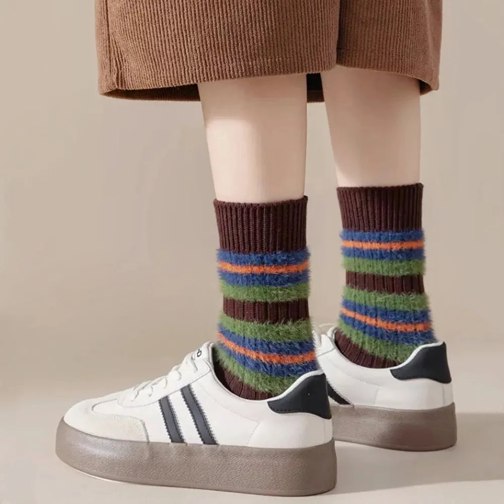Model wearing a pair of Plush Striped Socks in brown, great for daily wear and lounging.