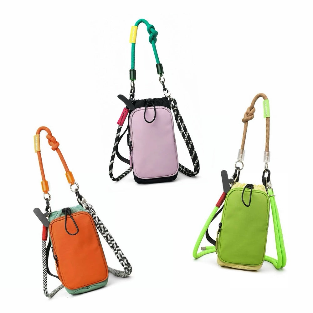 Group studio display of three colorways of the pop color utility bottle bag including orange, pink, and green