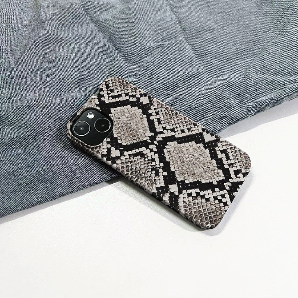 Realistic python skin motif on a durable silicone iPhone case. High-fashion animal print accessory.