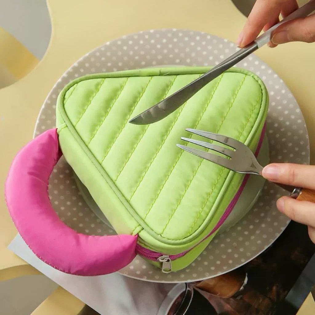 Green Puffy Candy triangle mini bag on plate; quilted zip pouch with pink handle for playful everyday storage.