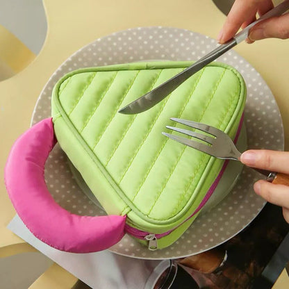 Green Puffy Candy triangle mini bag on plate; quilted zip pouch with pink handle for playful everyday storage.