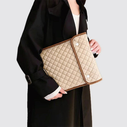 Model carrying a khaki  laptop sleeves handheld, great for daily carry and travel.