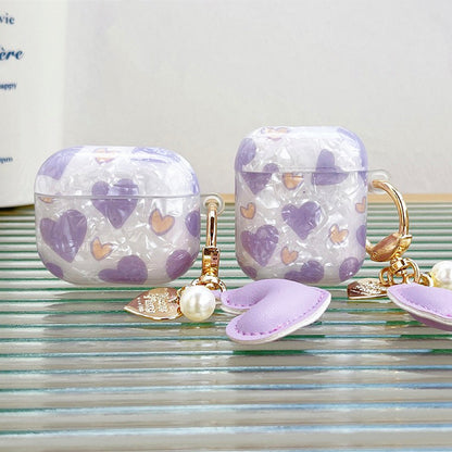 Angled view of two Purple Heart Shaped AirPods Case Covers, easy to carry for commutes and errands.