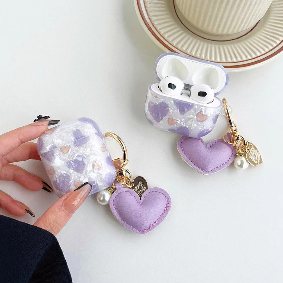 Model Hands holding a Purple heart-shaped airpods case cover, easy to carry for commutes and travel.
