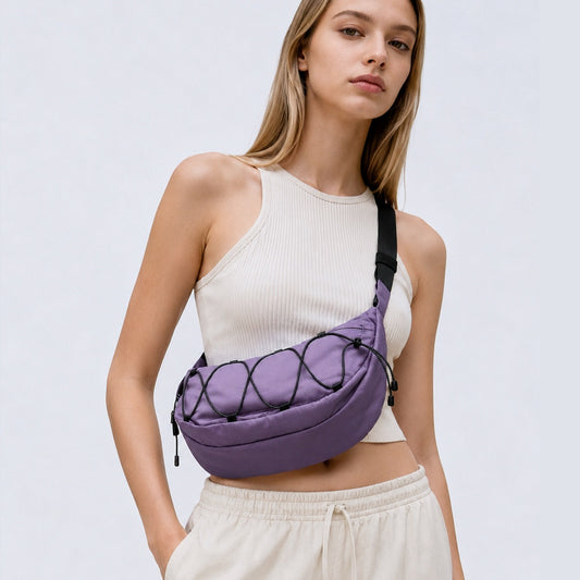 Model wearing a purple lightweight nylon crescent sling bag as crossbody, showcasing the effortless urban style.