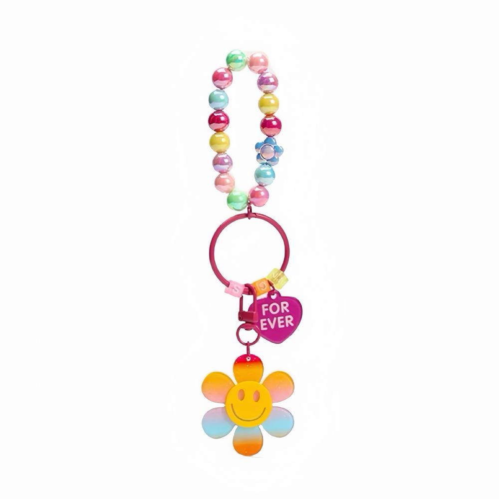 Front view of Acrylic rainbow beaded bag charm with a pink tag and a colorful smiley sunflower .