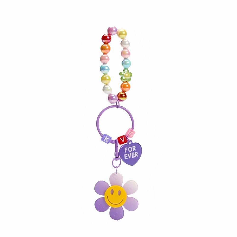 Flat lay of Rainbow Beads Sunflower Bag Charm in purple, great for everyday styling and gifting.