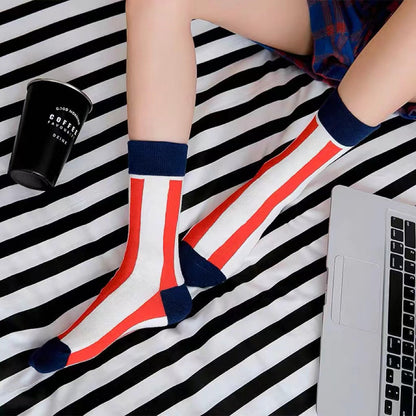 Model wearing a pair of red striped cotton socks, ideal for everyday outfits and sneakers.