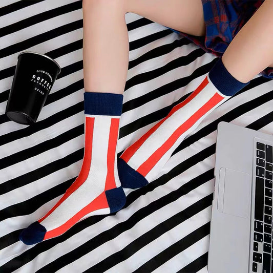 Model wearing a pair of red striped cotton socks, ideal for everyday outfits and sneakers.