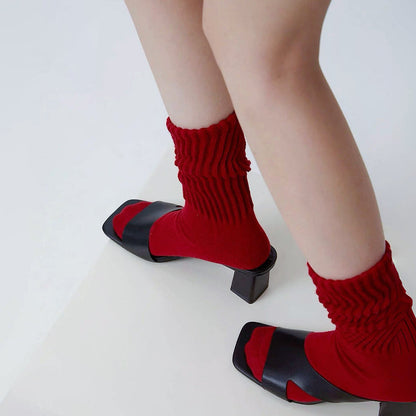 Model wearing a pair of red cotton slouch socks, great for casual wear and light workouts.