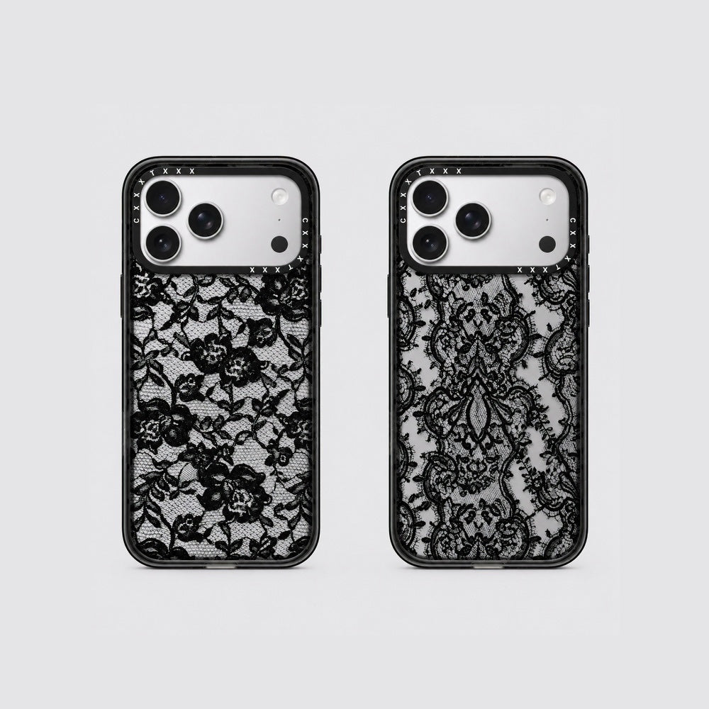 Flatlay view of two retro lace phone cases showing scroll lace and floral lace patterns on clear back panels.