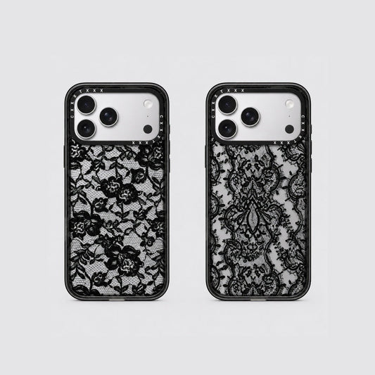 Flatlay view of two retro lace phone cases showing scroll lace and floral lace patterns on clear back panels.