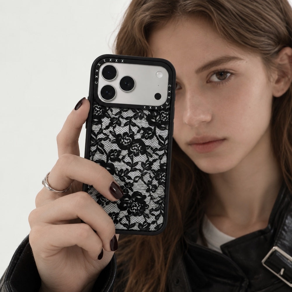 Female model holding the black rose lace clear phone case near her face showing intricate lace detail.
