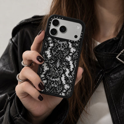 Model holding the retro lace iPhone case wearing a black outfit for a coquette aesthetic mirror selfie.