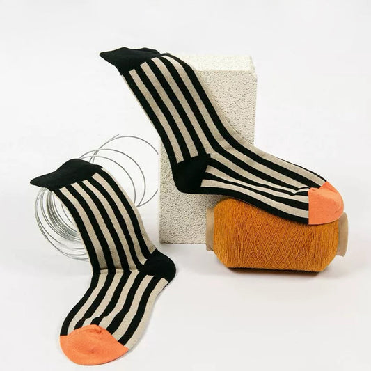 Front view of Retro stripe orange socks with black and beige vertical stripes.