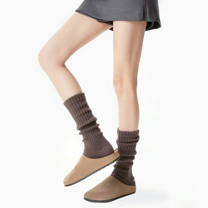 Model wearing a pair of brown  Ribbed Knit Leg Warmers, great for casual wear and light workouts.
