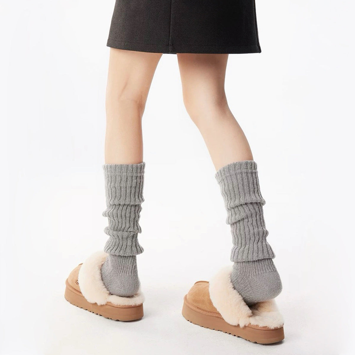 Model wearing a pair of light gray  Ribbed Knit Leg Warmers, ideal for everyday outfits and sneakers.