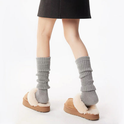 Model wearing a pair of light gray  Ribbed Knit Leg Warmers, ideal for everyday outfits and sneakers.