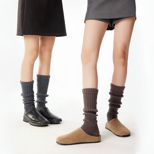 Two models wearing  Ribbed Knit Leg Warmers,one black and one brown.