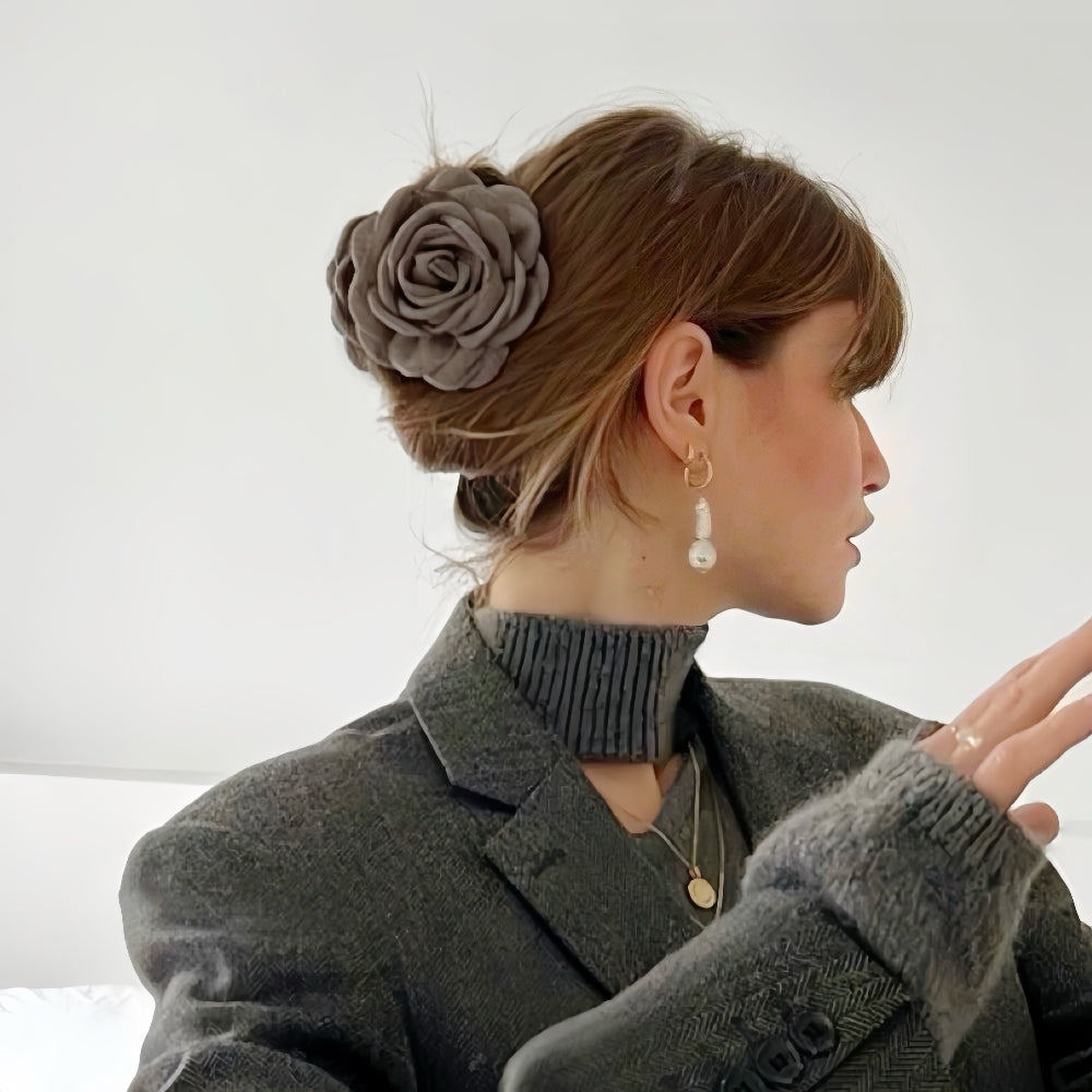 Model wearing a greige Rose Reveries Hair Claw, great for date nights and events.