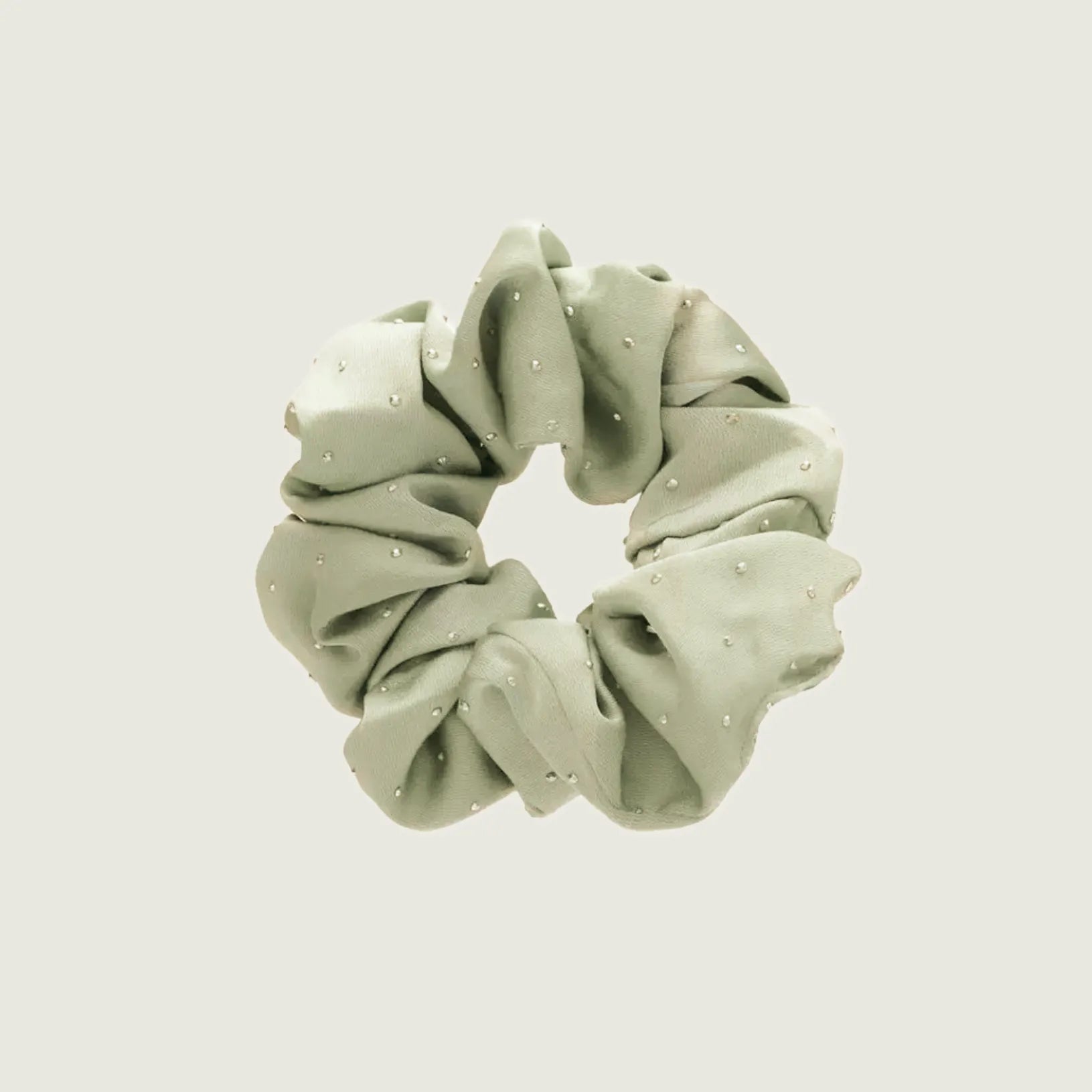 Folded view of Satin Scrunchie With Rhinestones in sage green, ideal for quick updos and ponytails.