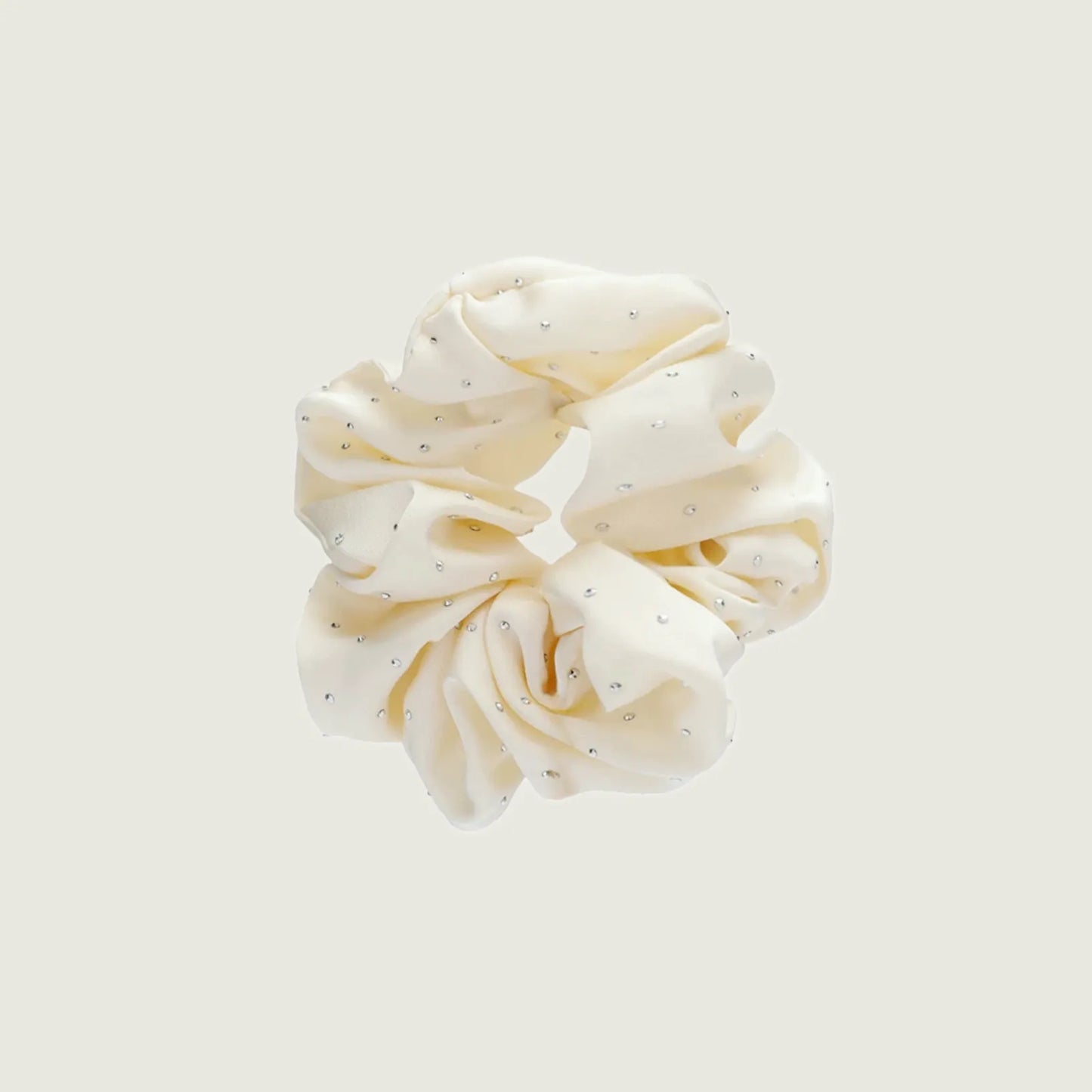 Angled view of Satin Scrunchie With Rhinestones in white, ideal for quick updos and ponytails.