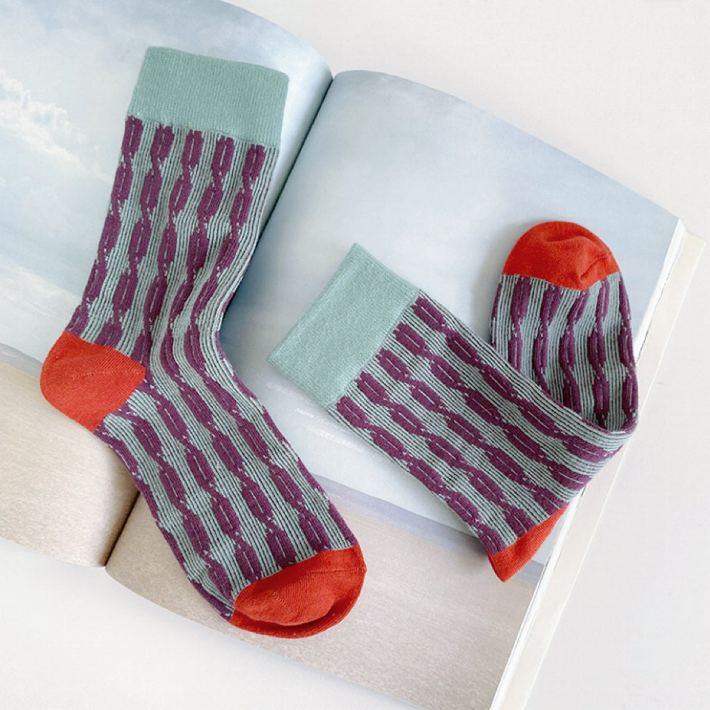 Flat lay of Sculptured Ripple Knitted Socks in green, great for daily wear and lounging.
