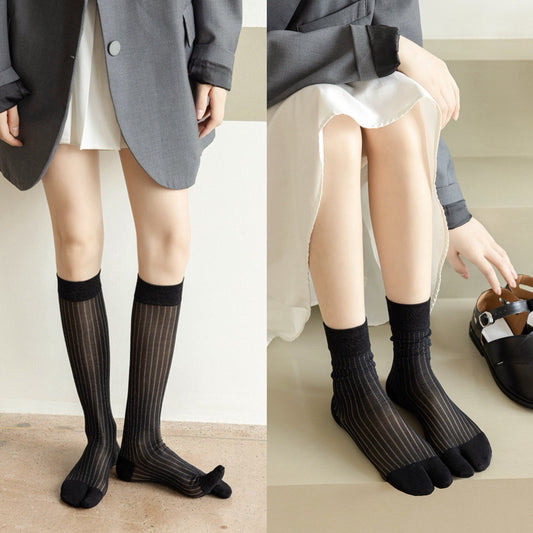 Two models wearing black split-toe socks with silver thread stripe, shown in knee-high and crew lengths.