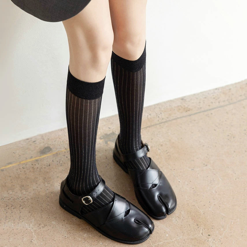 Model wearing black Striped Split-Toe Socks in knee-high, easy to pack for travel and errands.