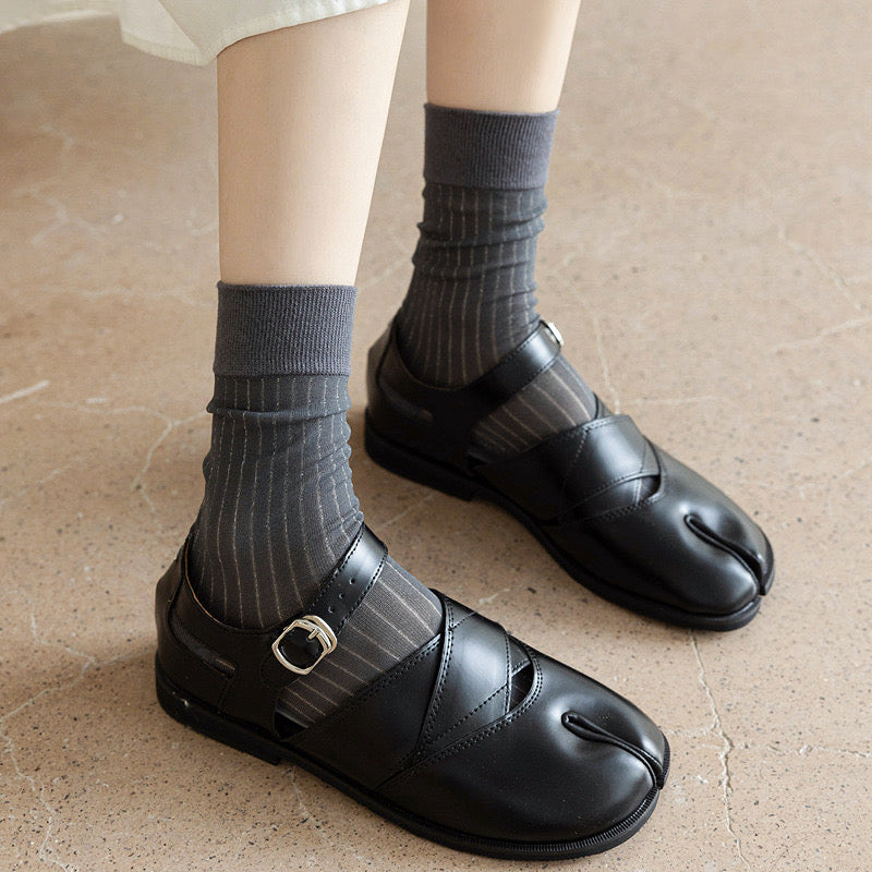 Model wearing a pair of grey striped split-toe socks in crew length, , great for casual wear and light workouts.