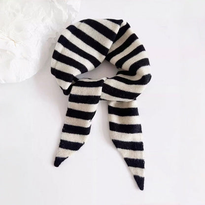 Angled view of Simple Striped Triangle Scarf in gray and black, great for office layering and commuting.