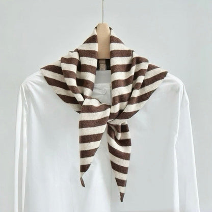 Angled view of the brown and white striped triangle scarf on a hanger, ideal for everyday styling and weekend outings.