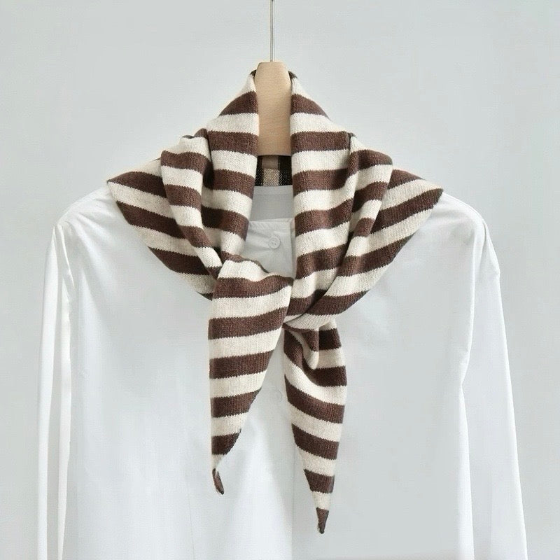 Angled view of the brown and white striped triangle scarf on a hanger, ideal for everyday styling and weekend outings.