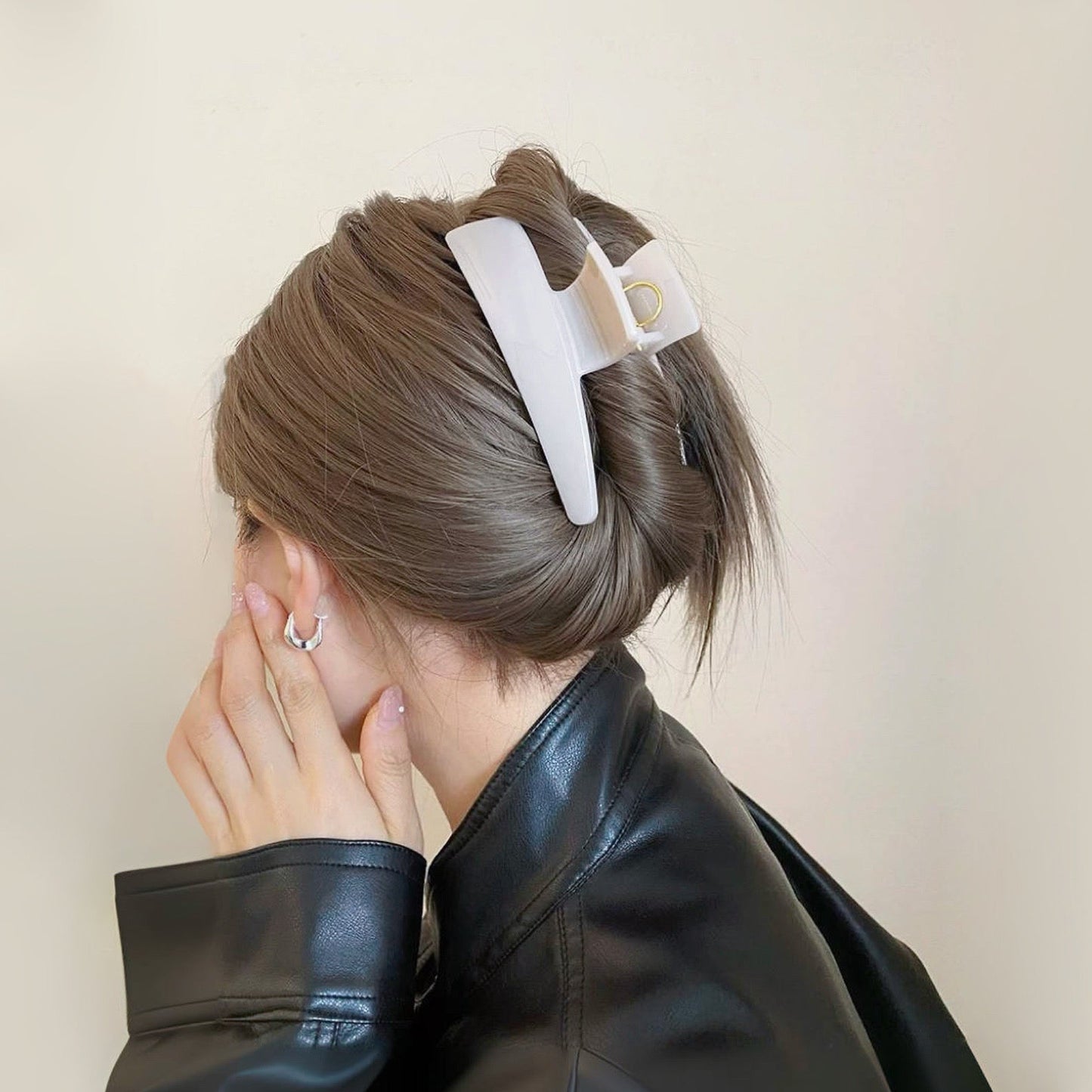 Model wearing a Sleek Curved Hair Clawp in white, ideal for quick updos and ponytails.