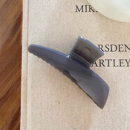 Angled view of Sleek Curved Hair Clawin gray, great for everyday styling and gifting.