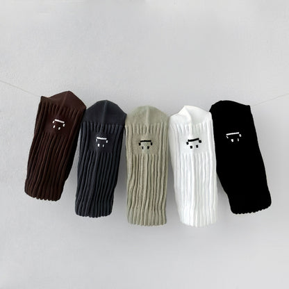 Close-up of 5 pairs of Smile Slouch Socks shown together, ideal for workouts and commuting.
