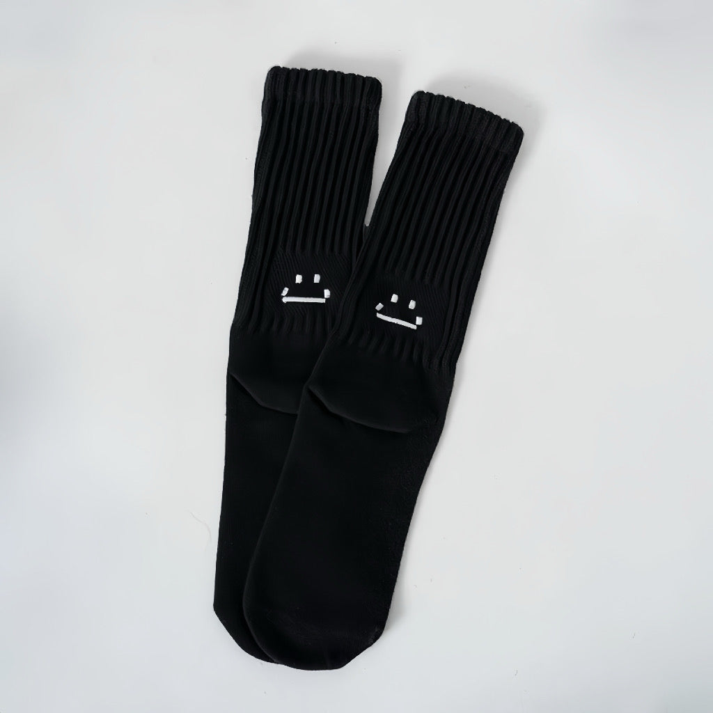 Front view of Smile Slouch Socks in black, easy to pack for travel and errands.