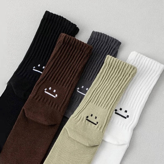 Front view of Five pairs of cotton-blend slouch socks in black, brown, charcoal, olive, and white.