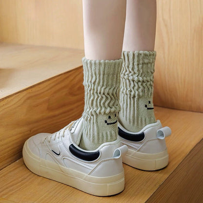 Model wearing a pari of Smile Slouch Socks in olive green, great for daily wear and lounging.