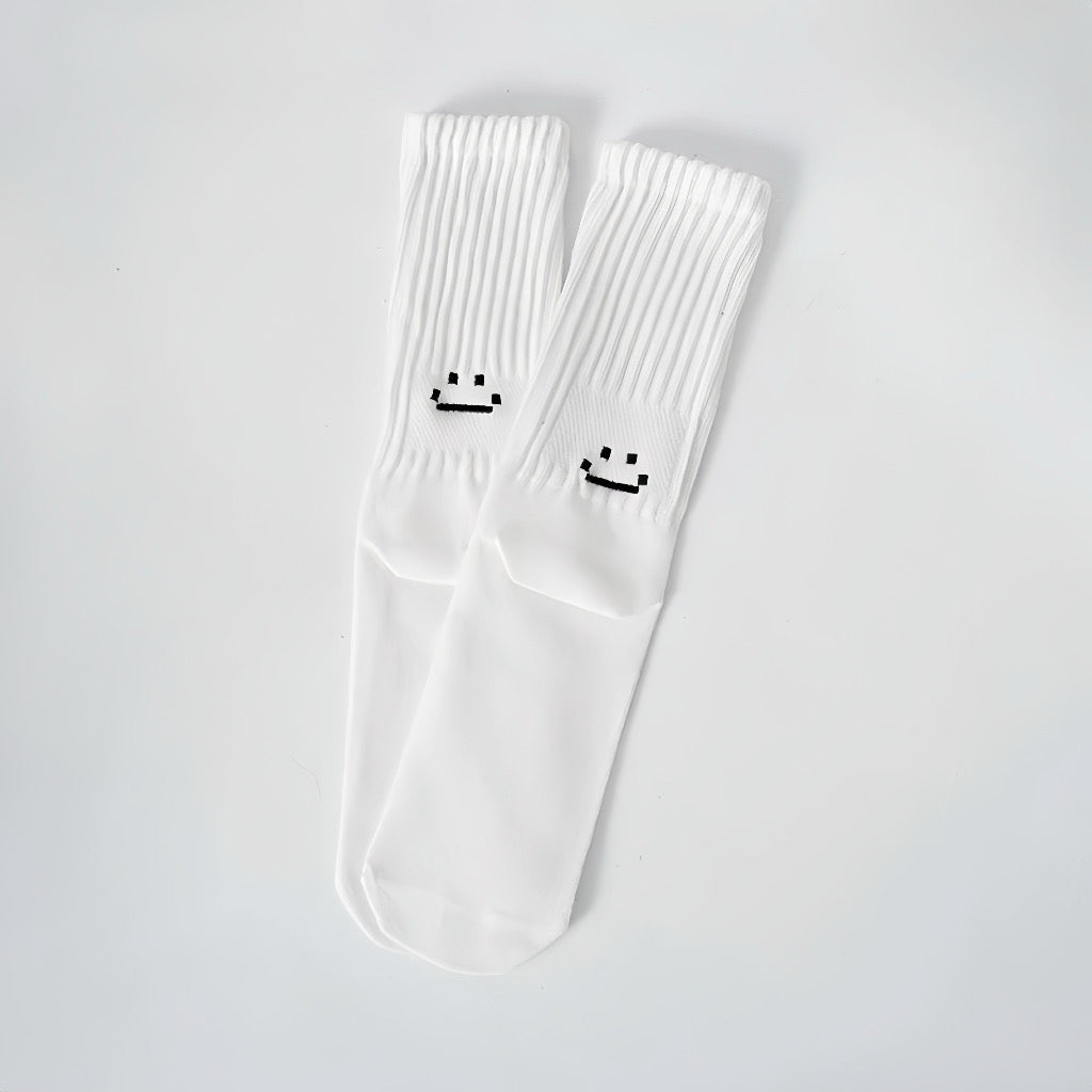 Folded view of Smile Slouch Socks in white, ideal for workouts and commuting.