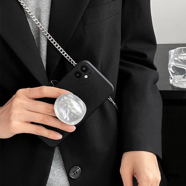 Model holding black Solid Color Case. Sleek professional matte finish with a durable gold stand.
