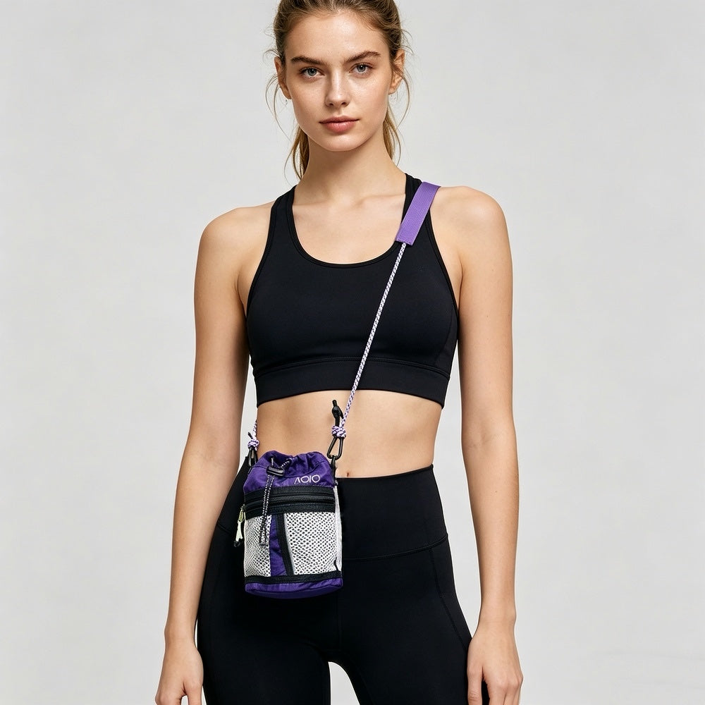 Model wearing the purple sporty mini bucket crossbody bag, featuring adjustable strap and zipper mesh pocket.