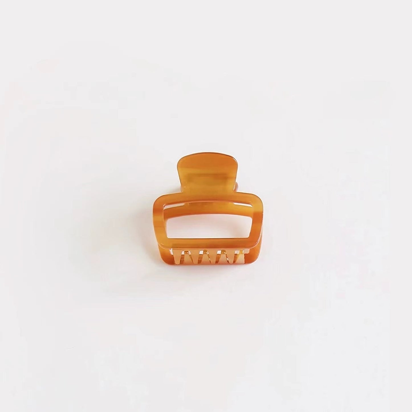 Glossy brown square hair claw on clean background, ideal for a casual daily look.