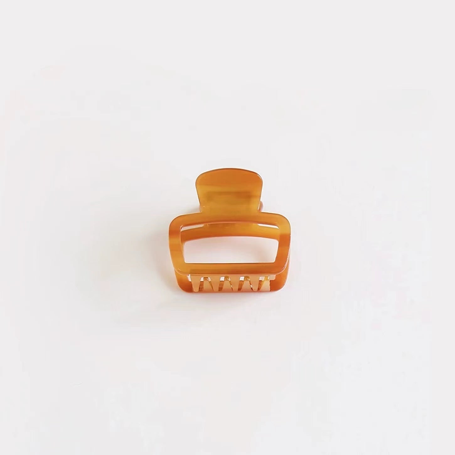 Glossy brown square hair claw on clean background, ideal for a casual daily look.