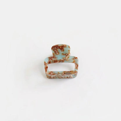 Cyan marbled square hair claw with glossy finish, ideal for refreshing spring hair styling.