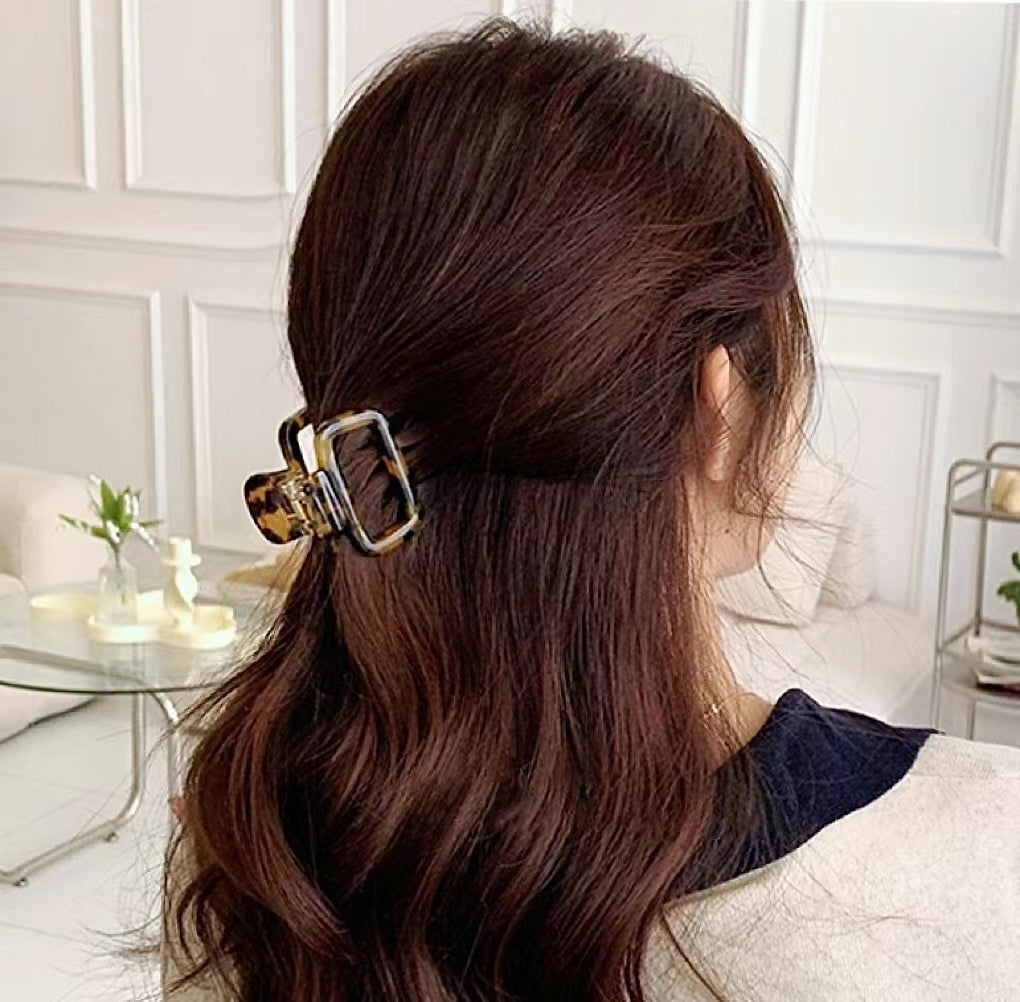 Back view of model with a dark leopard hair claw, strong grip ensures secure and elegant all-day wear.