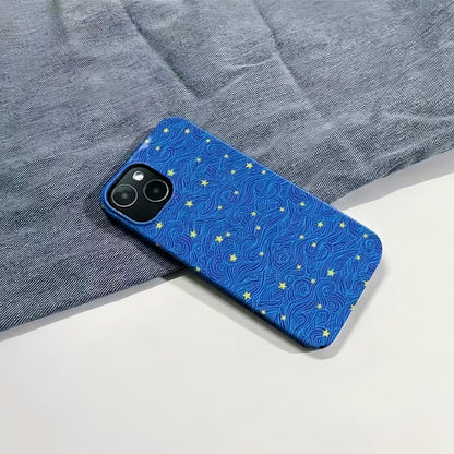 Blue Starry Night case with yellow stars and swirling lines, resting on a denim background.