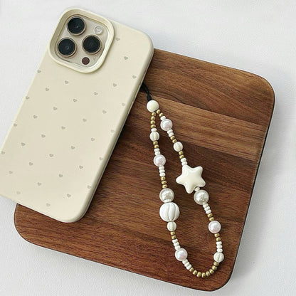 Angled view of a phone case with Starry Pearl Delight Phone Charm, easy to attach to bags and phones.